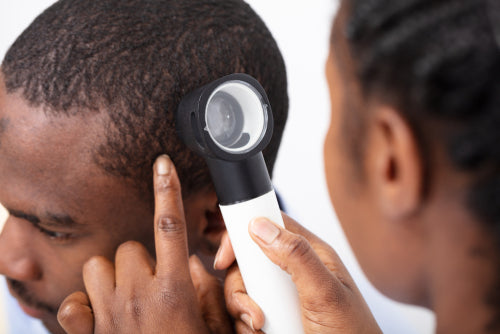 dermatoscope examining scalp dermatoscope examining scalp